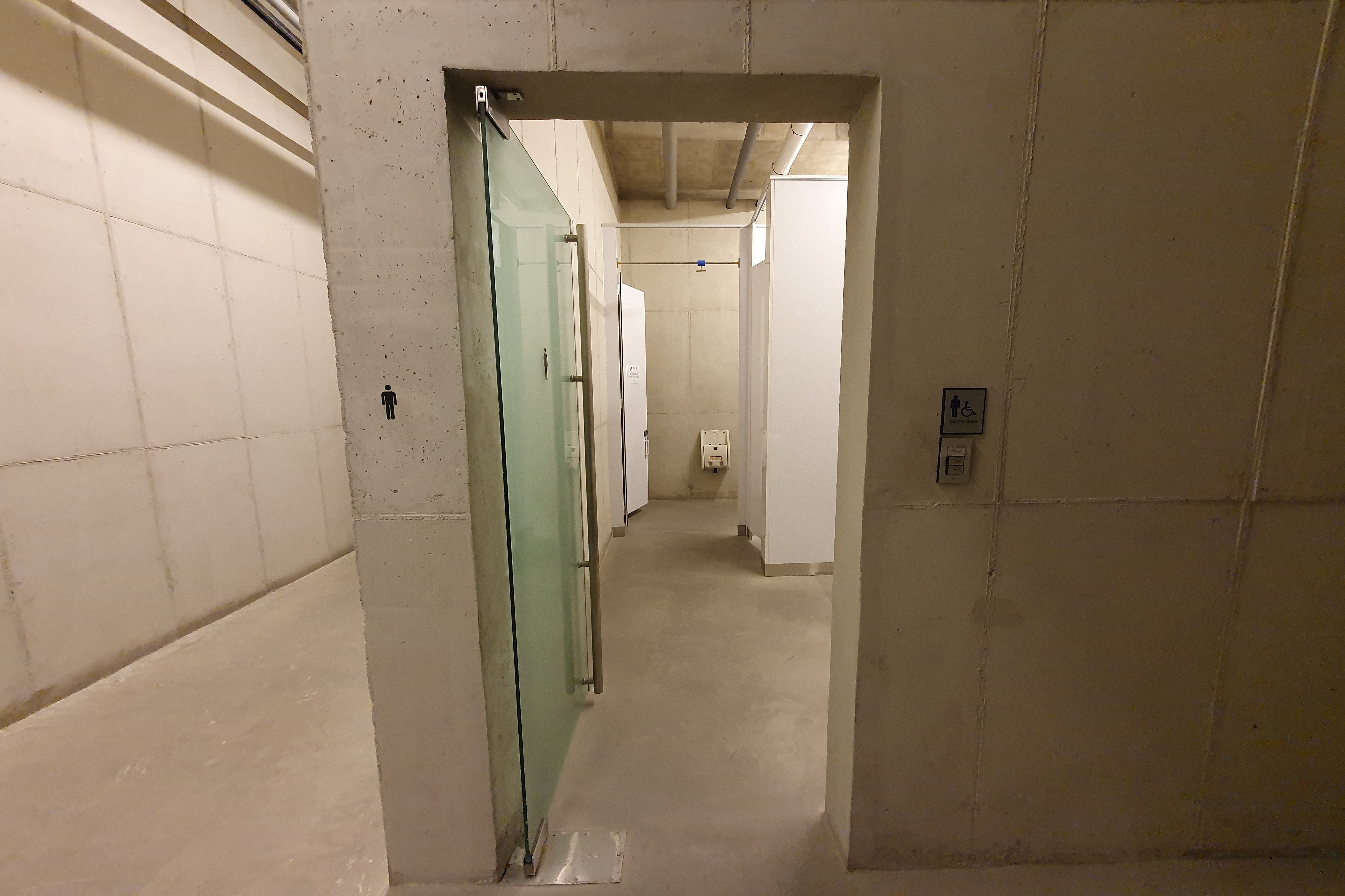 Accessible Restrooms0 : The restroom entrance with manual hinged door open