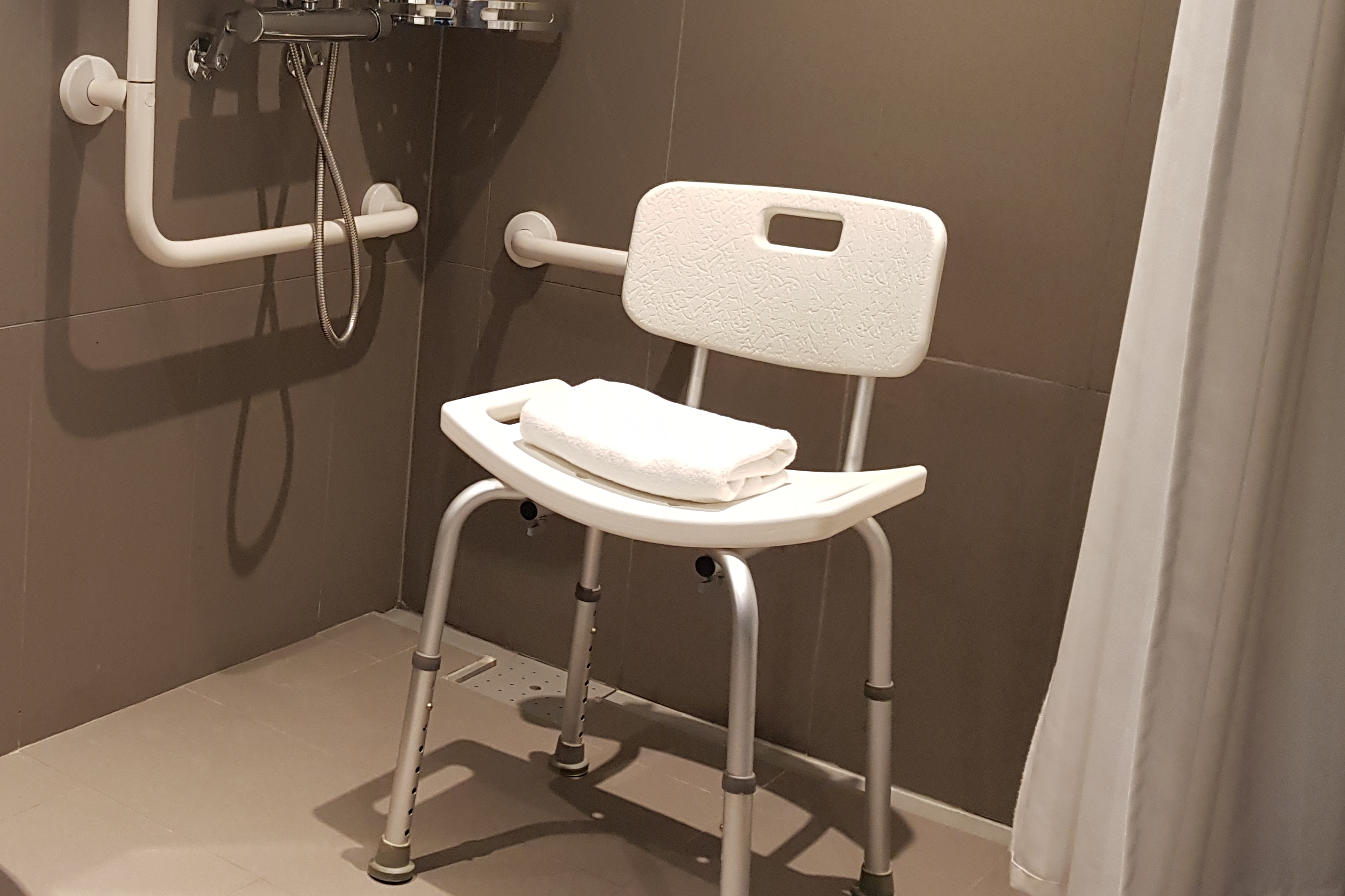 Bathroom0 : Restrooms of the L7 Myeongdong by Lotte equipped with a shower chair
