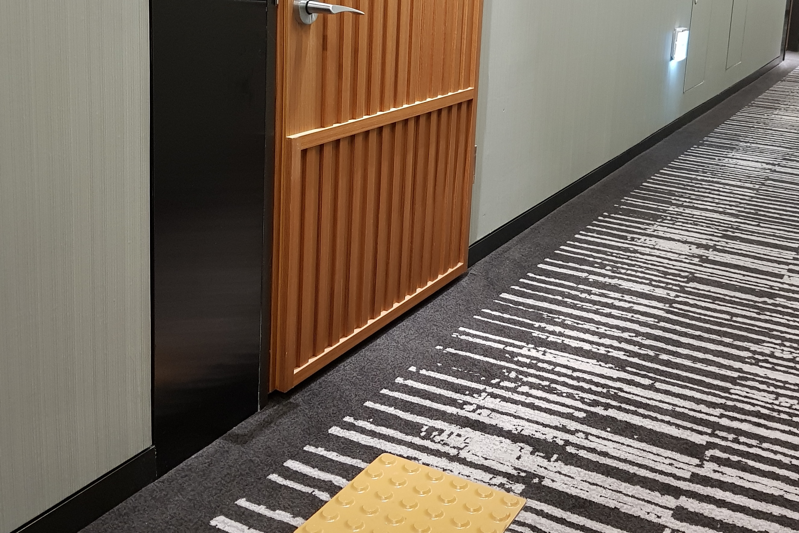 Guestroom Doorway0 : Main entrance of the Novotel Ambassador Seoul Dongdaemun Hotels & Residences with flat floor and tactile paving for the visually impaired
