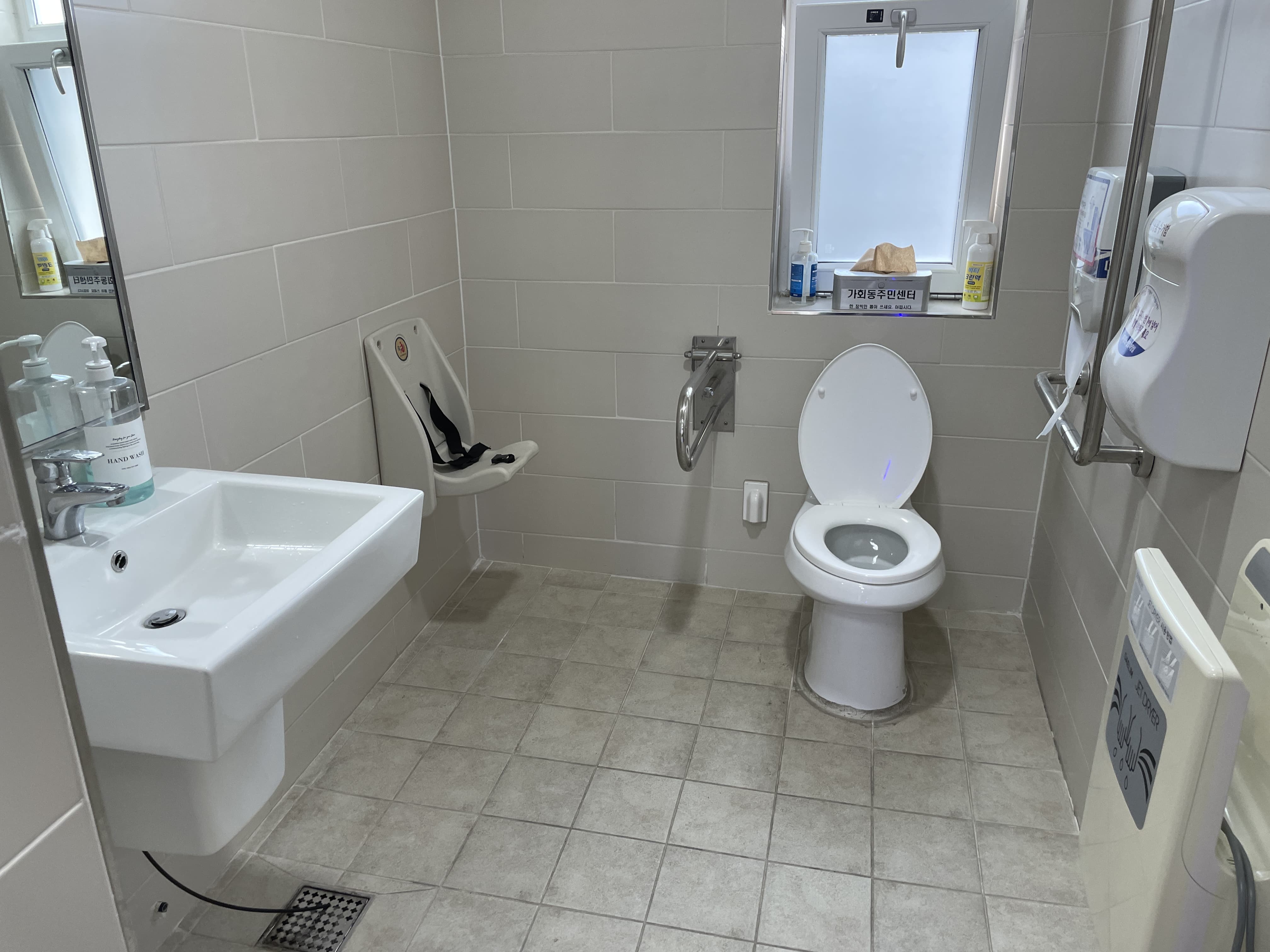 Accessible restroom for persons with disabilities 0 : A single-user accessible restroom with a spacious interior 