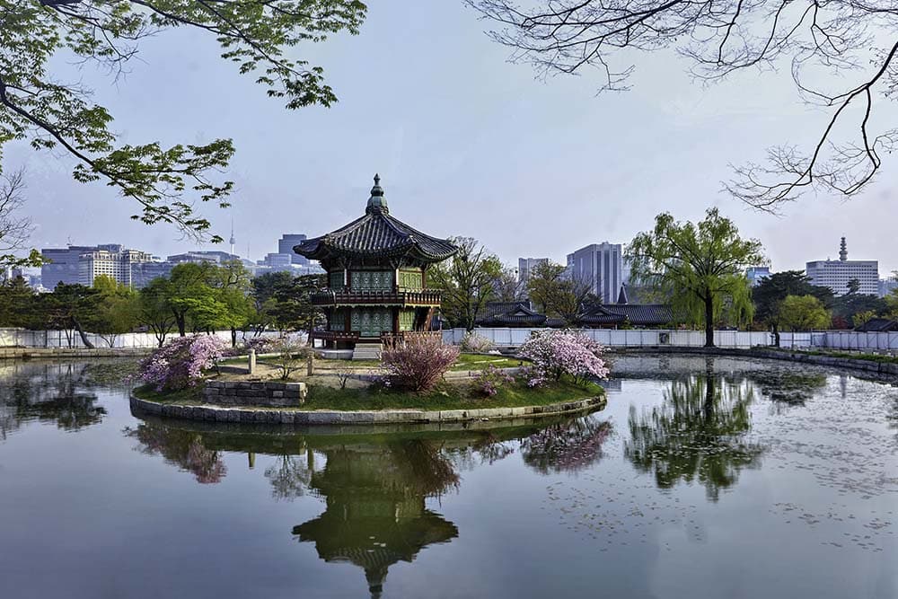 Gyeongbokgung Palace0 : A view of a two-story traditional pavilion in the middle of a lake
