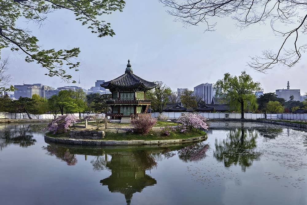 Gyeongbokgung Palace0 : A view of a two-story traditional pavilion in the middle of a lake
