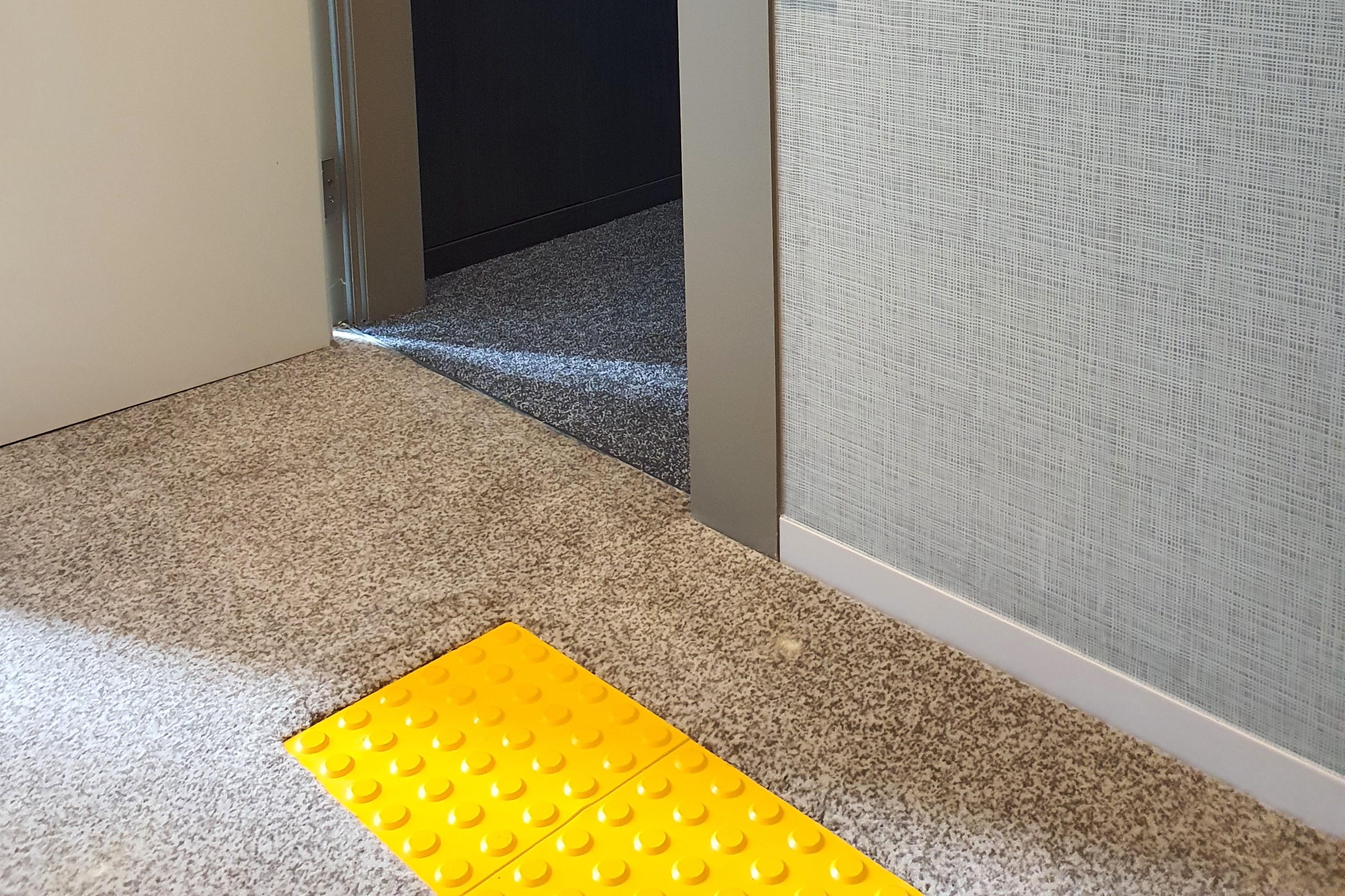 Entryway0 : The main entrance of the room with no steps and blind braille block installed