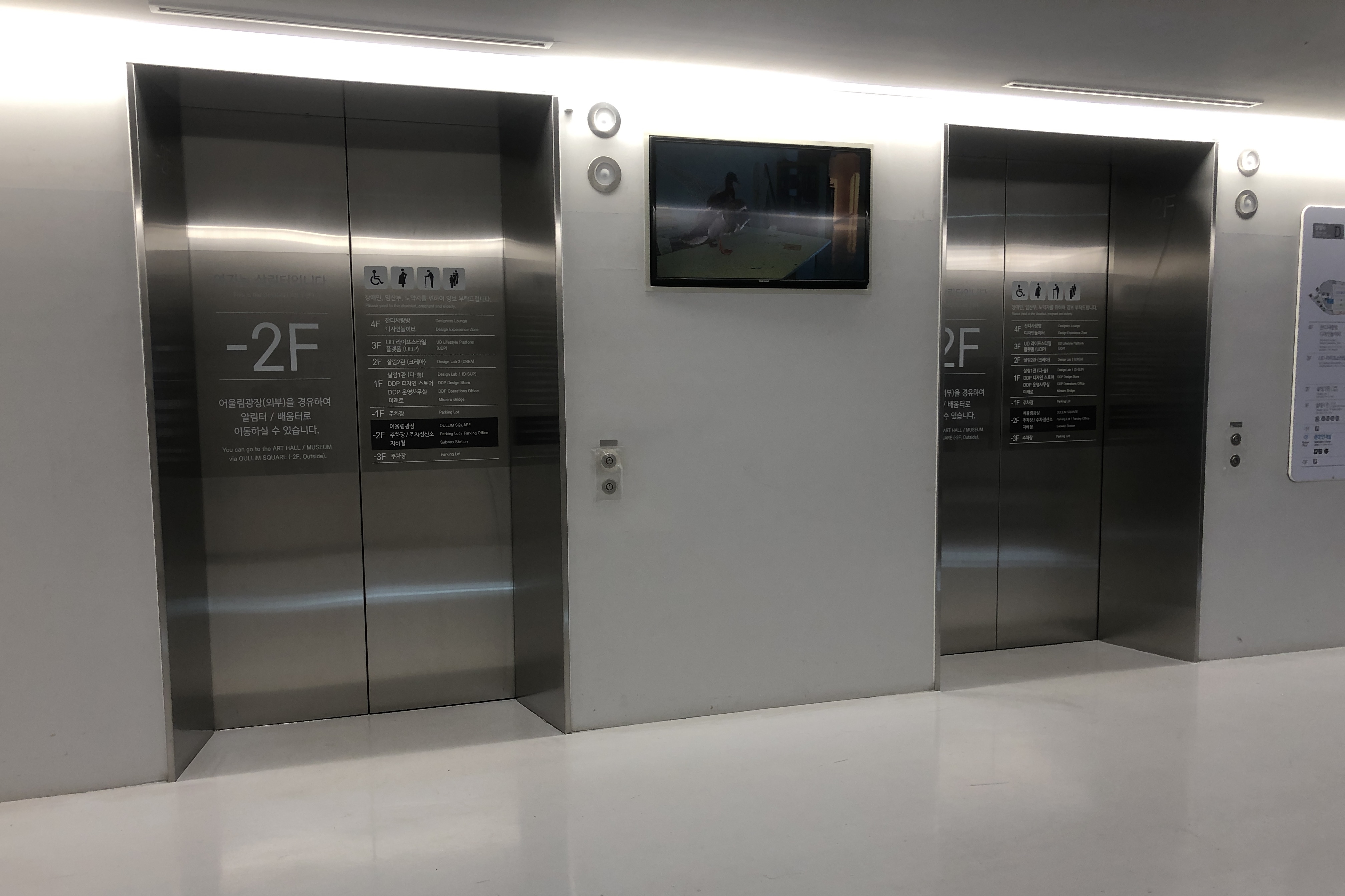 Elevator0 : exterior view of elevatiors with pictograms of wheelchair users, pregnant women, and senior

