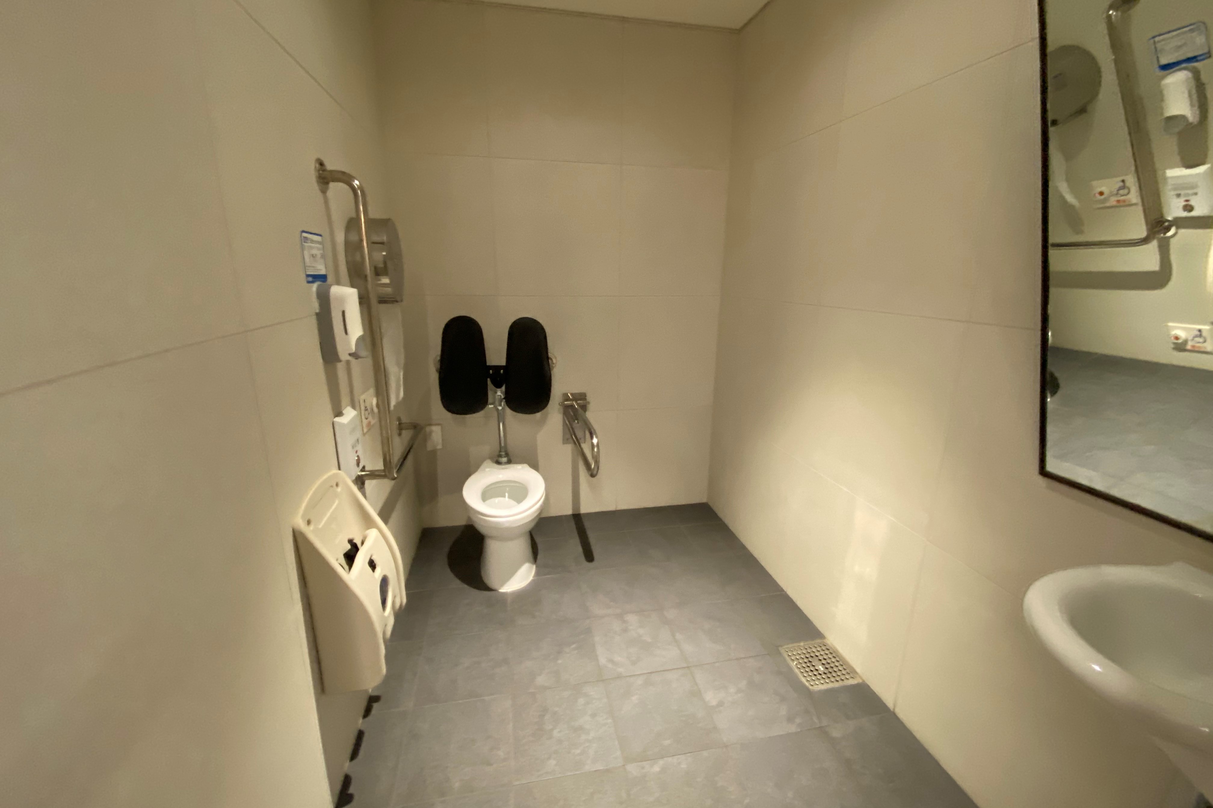 Accessible restroom for persons with disabilities0 : Interior view of a spacious accessible restroom