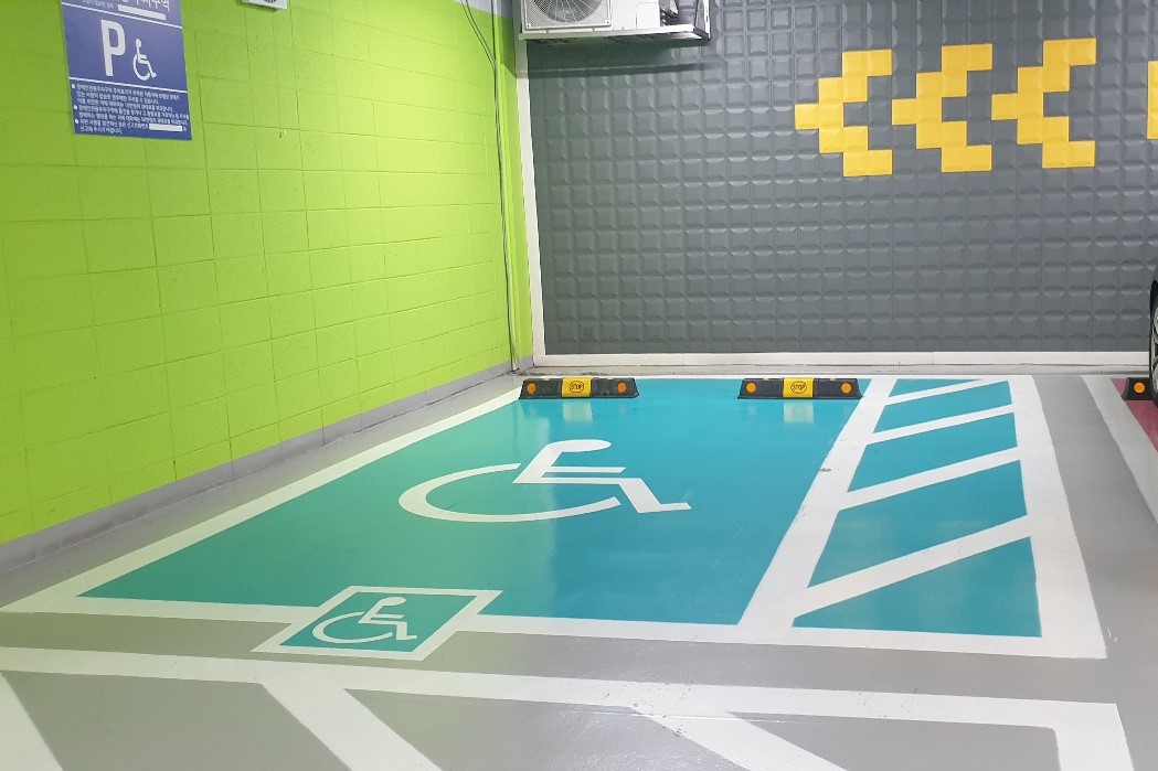 Parking facilities for persons with disabilities0 : A parking space for persons with disabilities with corss-hatched stripes