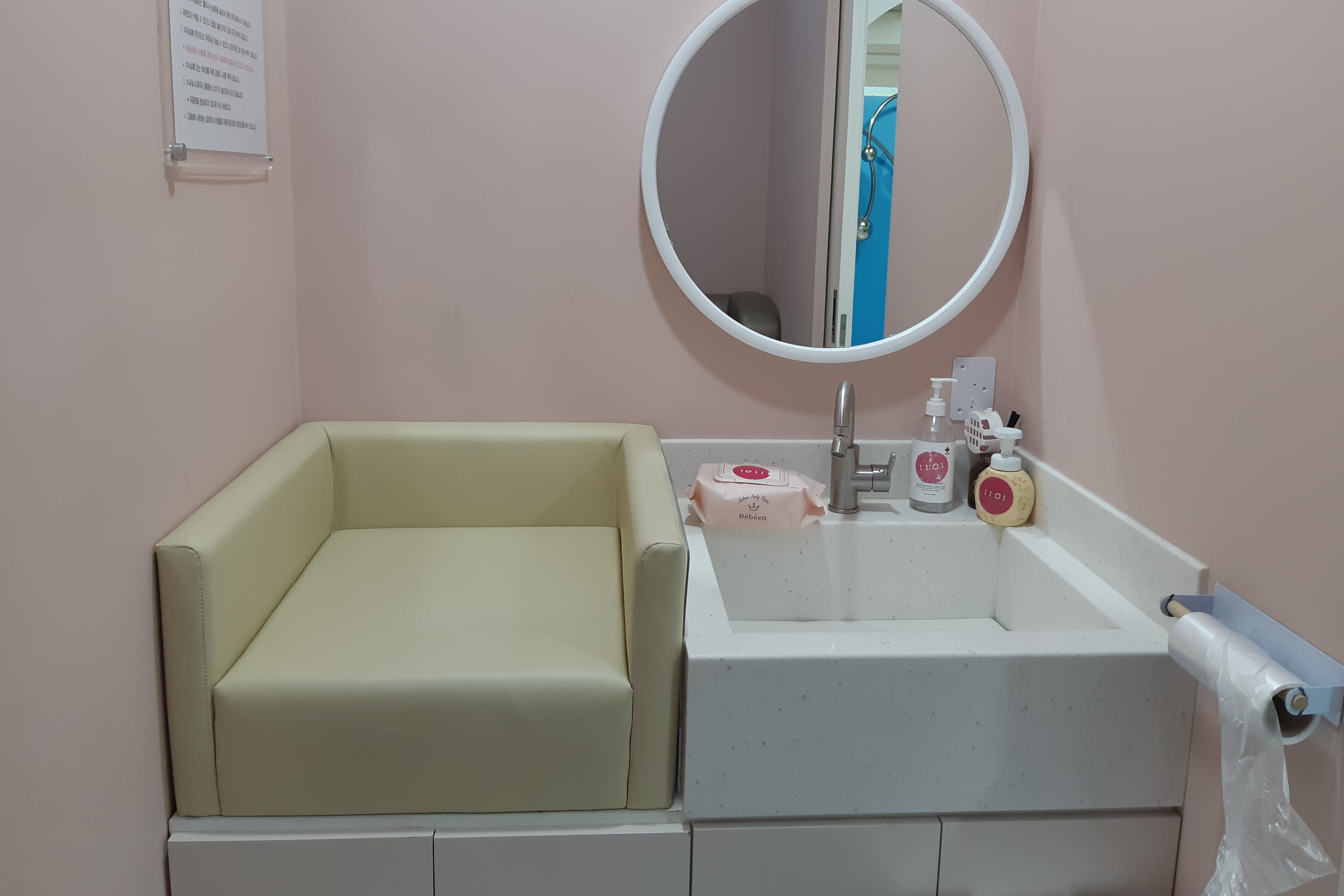Nursing room near the Children resting area0 : Interior view of the nursing room with diaper changing station, basin, mirror, wet tissues and  hand sanitizer
