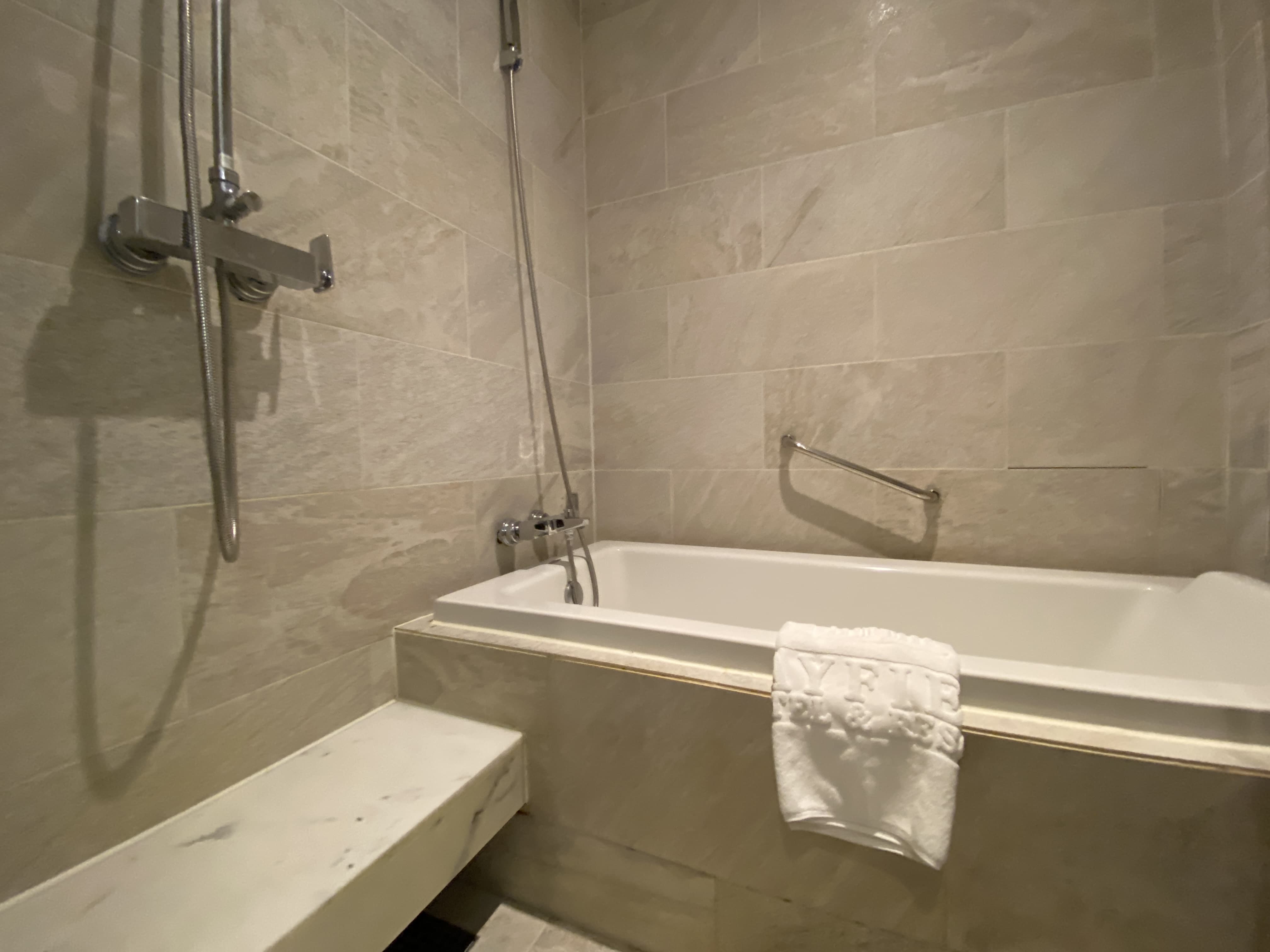 Premier Suite guest room0 : A bathroom with a bath tub