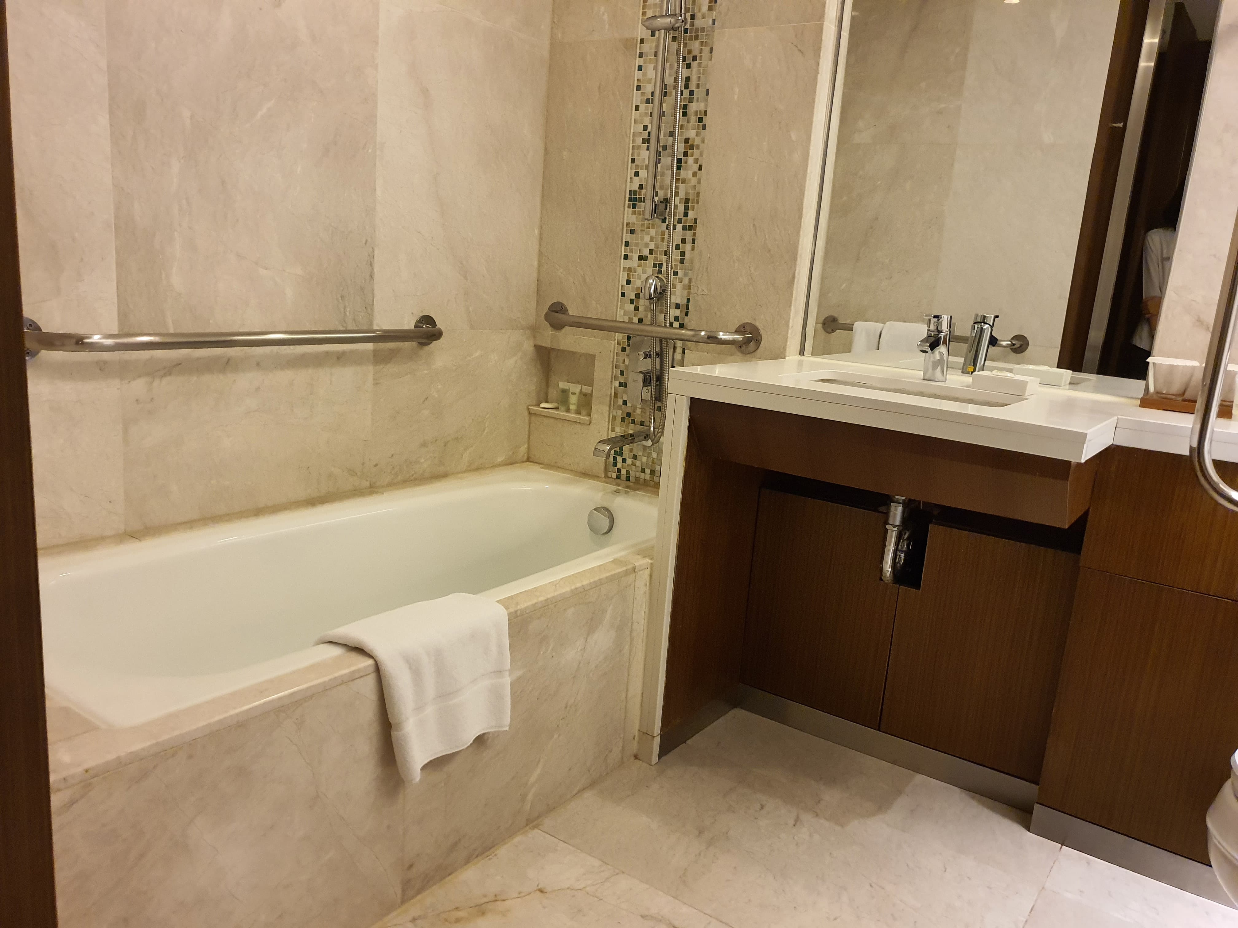 Accessible restroom for persons with disabilities0 : Bathroom with a sink and a bath tub