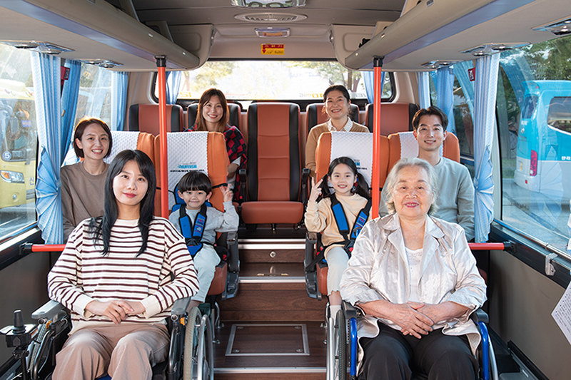 A photo of the family, including two wheelchairs, on a minivan Danurim tour bus